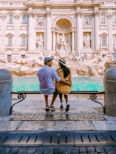 couple sitting in front of fountain in Rome