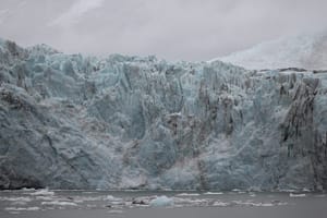 Travel to see these Ice blue glacier with streaks of black