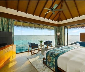 bedroom with wall to wall windows with open water views