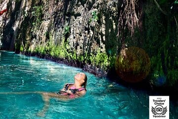 girl floating in cave river