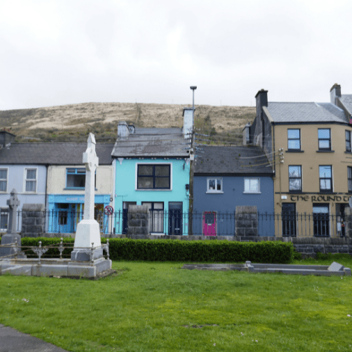 A row of houses painted in different shades of blues and tans in the Ring of Kerry
