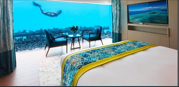 underwater bedroom with floor to ceiling view of the ocean