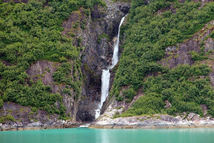 waterfalls in the middle of the mountain