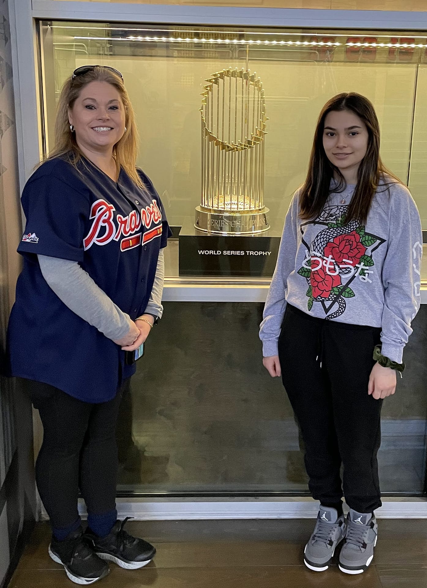Adventures with my daughter Mom and daughter standing in front of the 2021 World Series trophy